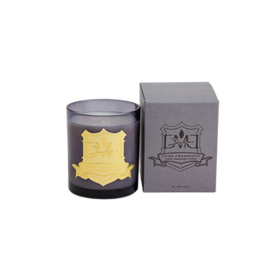 Water Wood candle in blue glass with gold crest beside the grey DMJ Home Fragrance gift box