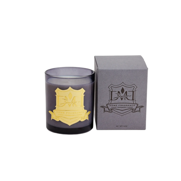 Water Wood candle in blue glass with gold crest beside the grey DMJ Home Fragrance gift box