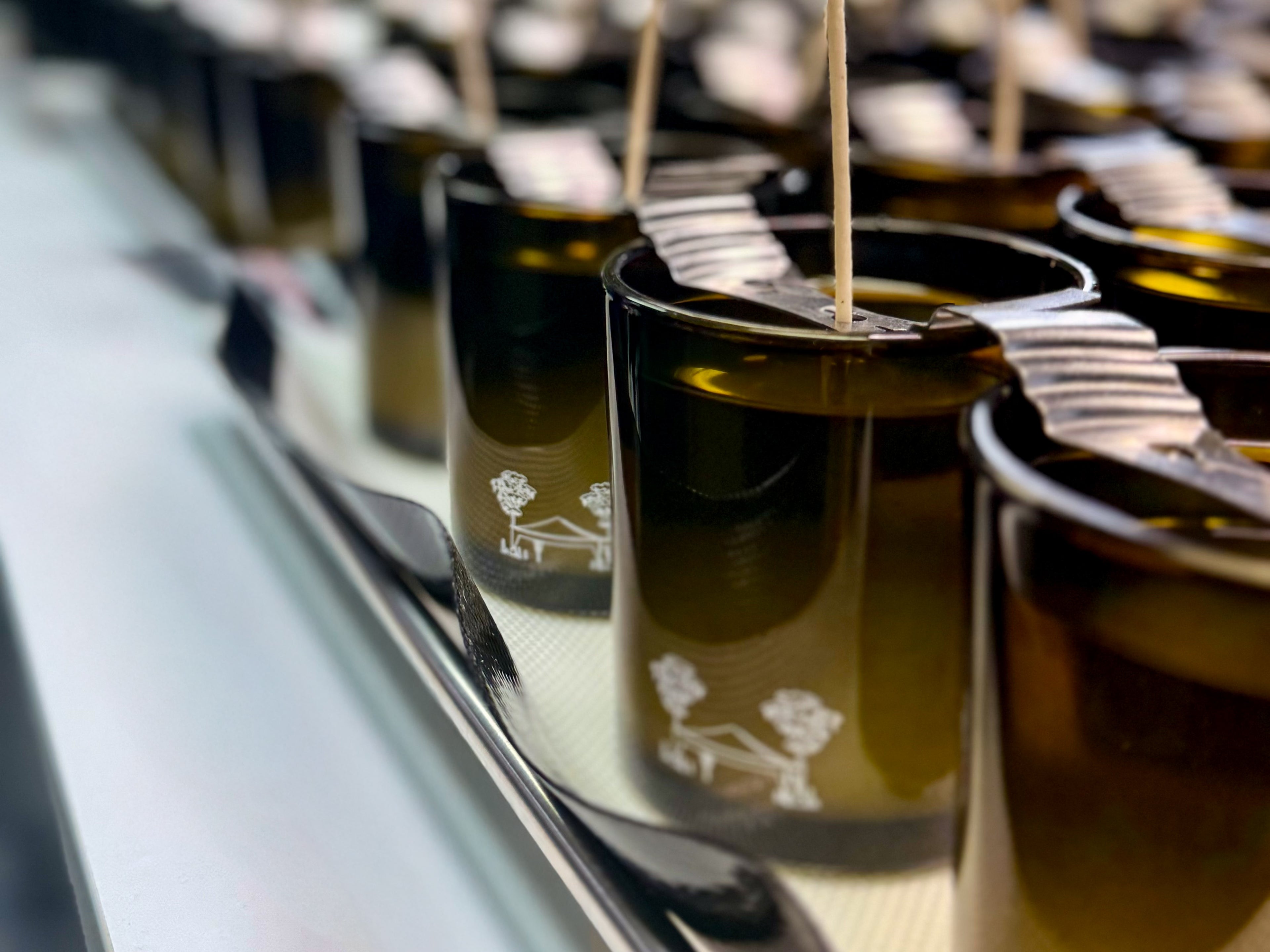 Hand-poured private label candles in production at DMJ Home Fragrance using luxury coconut wax and custom fragrance formulations.