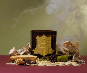 Noir candle by DMJ Home Fragrance with cacao, coffee beans, almonds, and moss under drifting smoke