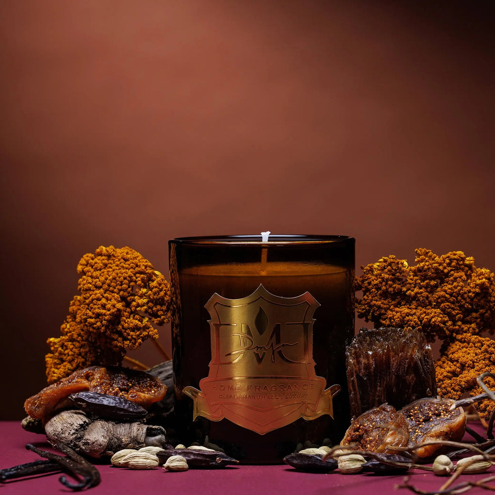 Sweet Pepper candle by DMJ Home Fragrance in amber glass with gold crest, styled with vanilla pods and warm spices